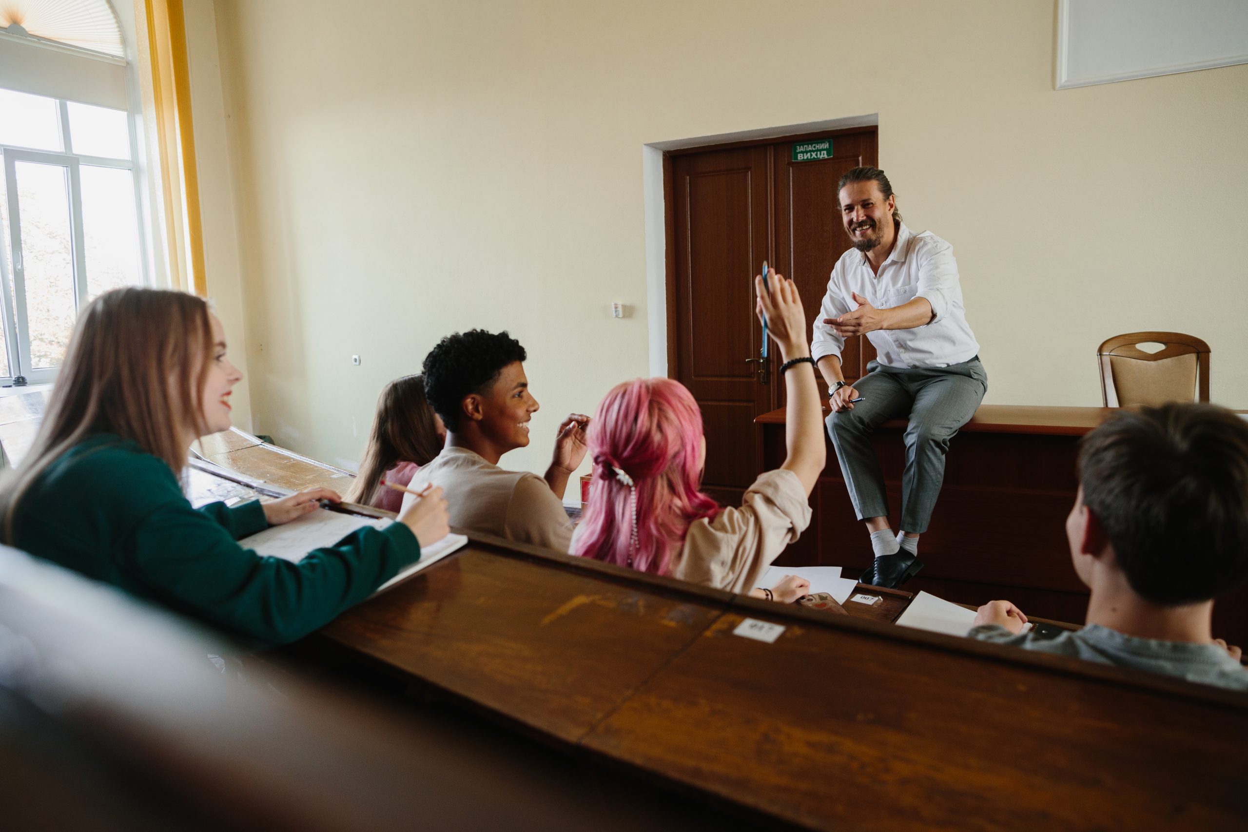 Higher education class with a lively discussion as students engage with an enthusiastic teacher.